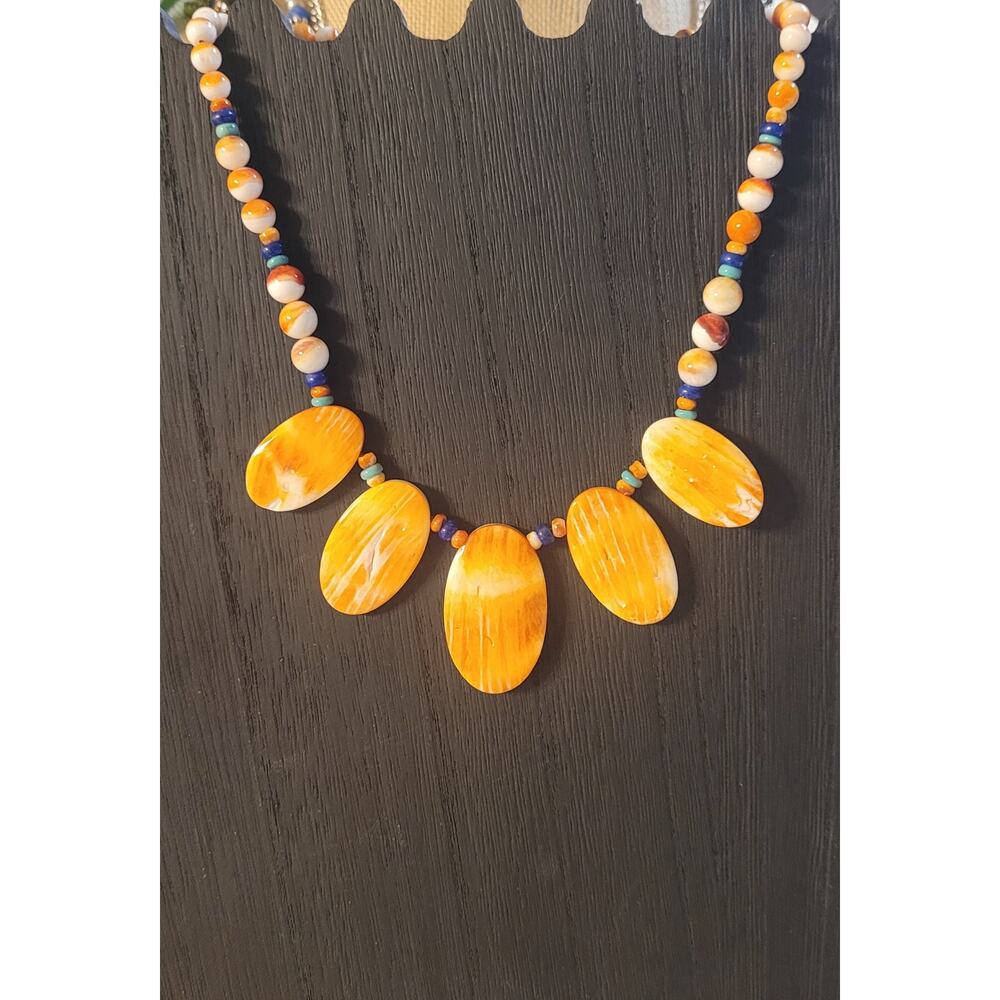Vibrant orange spiny oyster shell pendants combined with various colored beads
